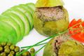 round zucchini filled mince meat served with tomatoes and peas
