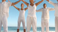 Peaceful people practicing yoga the beach