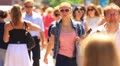 A crowd of people in the summer city. editorial slow motion