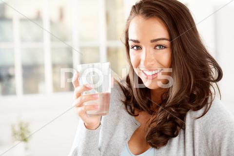 Attractive Young Woman Drinking Coffee At Home