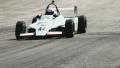 Formula 1 car passes by hot racing track tarmac Video