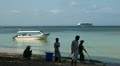 Beach cleaners, boat and cruiseship at Bali beach Video