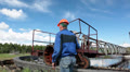 Senior Caucasian worker in a helmet maintaining at the water treatment plant Video