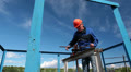 Mature manual worker shut off oil valve gate on big diameter pipeline Video
