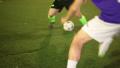Football player (forward) tricks with a ball in soccer match, click for HD