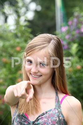 Happy Teenage Girl Pointing At The Camera