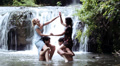 boys and girls are having fun in a river, struggling and splashing with water Video