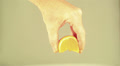 hand of man compress an orange segment close up Video