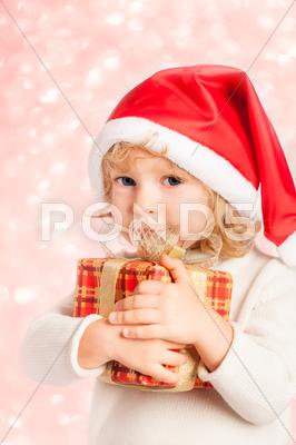 Stock photo of Baby hält Weihnachtsgeschenk in den Händen