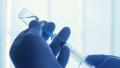Nurse filling injection syringe from vial