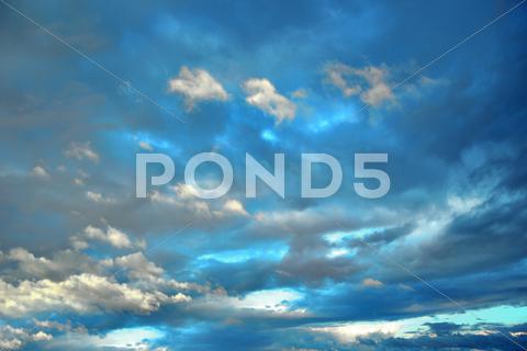 Stock photo of background of deep blue sky with fluffy clouds