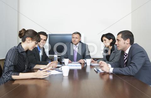 Business People Having Discussion In Conference Room