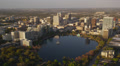 Wide aerial shot flying over Lake Eola while approaching Downtown Orlando