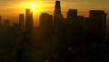 Aerial view of silhouetted Los Angeles skyscrapers at sunrise