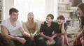 Young people socialising together and having fun. Student house accommodation.