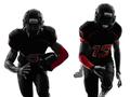 two american football players running silhouette