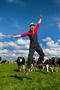 happy farmer in field with cows