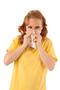 red haired woman blowing nose