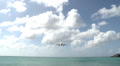 Long Shot of a Plane Flying Directly Overhead in Caribbean