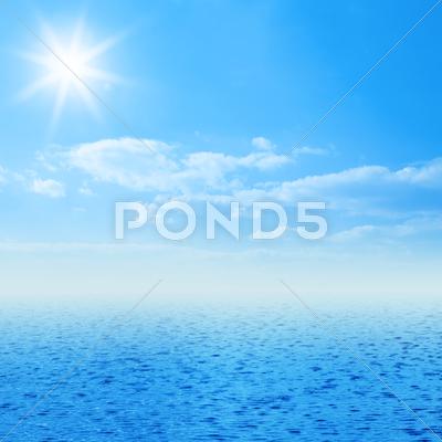 Stock Illustration of blue sea image with clouds and sun on sky