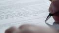DOLLY: Male hand takes the pen and signed a contract