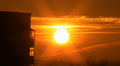 Night city, a sun goes down near houses