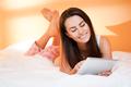 brunette beauty browsing.gorgeous young brunette woman using tablet computer in