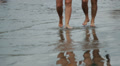 Couple walking on sand beach Video