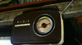 Radio Hanging on a Wooden Beam in a Shed