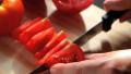 Woman cut up a tomato with a knife Video