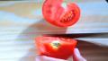 Woman slicing tomato Video