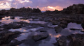 Rocky Alien Landscape with Rock Pools Reflecting a Beautiful Sunrise