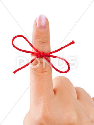 Stock photo of Red bow on finger