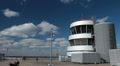 jet airplane taking off by radar control tower at dusseldorf airport.