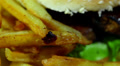 Hamburger with fried potato in rotation. Macro Video