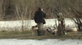 Fishermen and dog on the river bank Video