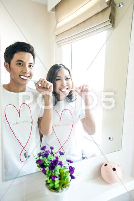 Stock photo of couple with toothbrushes