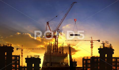 Big Crane And Building Construction Against Beautiful Dusky Sky Use For Const