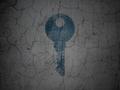 Safety concept: Key on grunge wall background