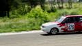 Two racecars approaching in hot pursuit, take turn, drive away Video