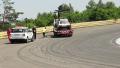 Evacuator removes broken racing auto from track, crew leave road Video