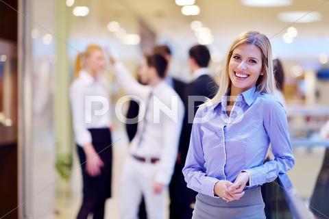 Business Woman With Her Staff In Background At Office