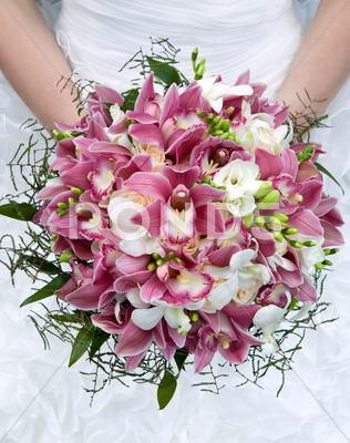 Bouquet Of Orchids, Roses And Other Flowers In The Bride\'s Hands Closeup.