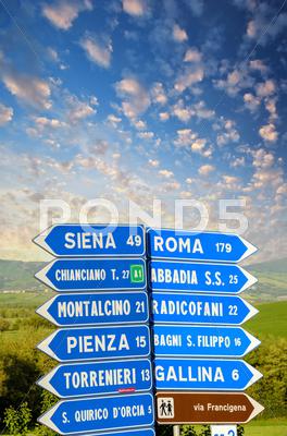 Stock photo of Road signs pointing different directions in Tuscany