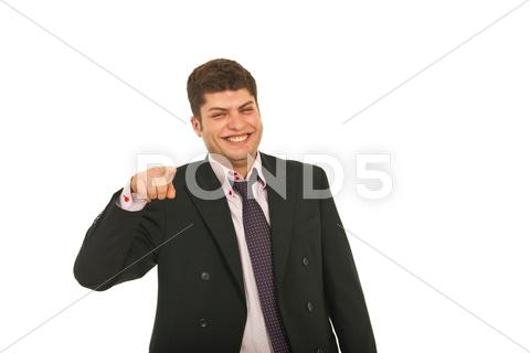 Stock photo of Laughing business man pointing to you