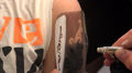 Applying a tattoo on the arm of the girl. 4K. Video