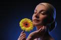 close-up portrait of a beautiful woman with gerber flower