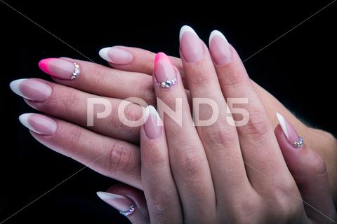 Pink And White Painted Nails With Hands Isolated On Black Background