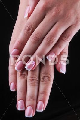 Painted Nails With Flowers And Hands Isolated On Black Background