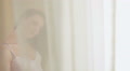 Young pretty girl looking into the window and feeling nostalgic Video